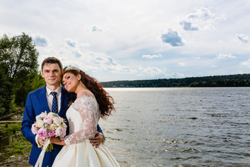 Beautiful couple newlyweds near the lake