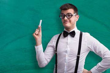 Close-up Of A Young Teacher Holding Chalk