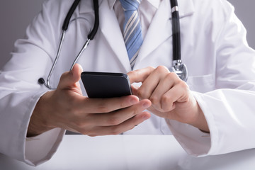 Doctor Using Smartphone In Clinic