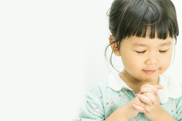 Little girl praying in the morning.Little asian girl hand praying,Hands folded in prayer concept...
