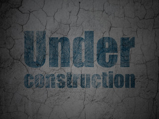 Web development concept: Blue Under Construction on grunge textured concrete wall background