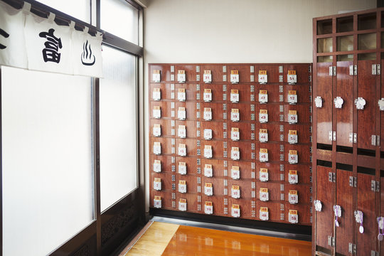 The interior of a public bath house, with rows of shoe lockers and clothes lockers. 