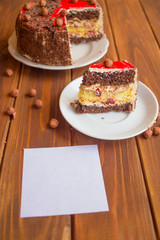Chocolate cake with a cherry on a wooden table. Sweet dessert for Valentine's Day
