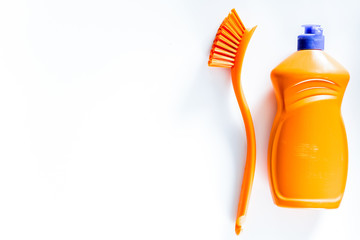 Dishwashing liquid and brushes on white background top view copy