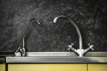 Close up to a stainless steel kitchen sink.