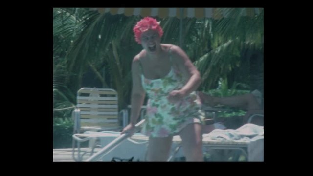 1971 Funny Woman in pink bathing cap dives in pool