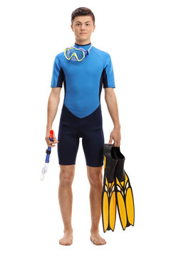Teenage boy in a wetsuit with snorkeling equipment