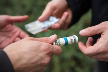 Person Buying Drugs In Exchange Of Money