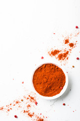 Ground pepper, peppercorn and fresh chili pepper on white