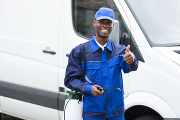 Young Smiling Male Worker With Pesticide Sprayer