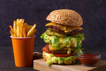 Scrumptious beef burger with fries - obrazy, fototapety, plakaty