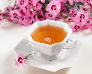 Cup of green tea on white table