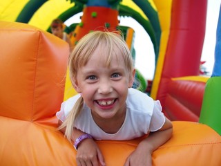 Fototapeta na wymiar Child playing in bouncy castle
