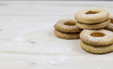 Delicate shortbread cookie with apricot marmalade on a wooden table  Minimal baking concept. 