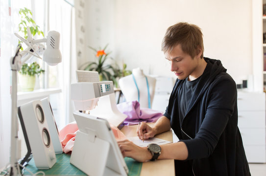 fashion designer with tablet pc working at studio