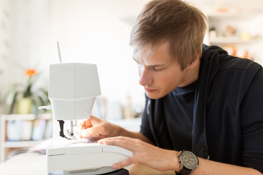 fashion designer with sewing machine at studio