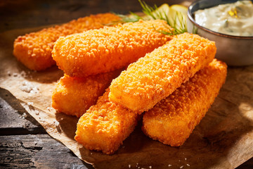 Crispy fried fish fingers in close up view
