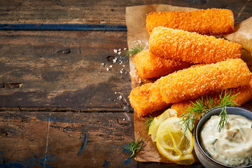 Deep fried fish fingers with lemon and sauce