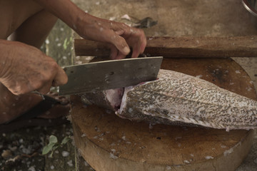 Chopping grouper fish before cooking