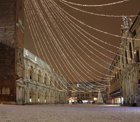 Vicenza in Italy by night with snow and Christmas lights