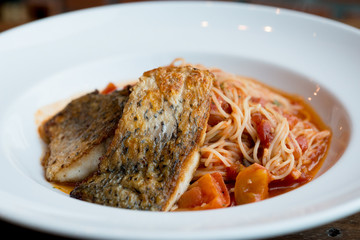 Grilled sea bass and spaghetti with tomato sauce