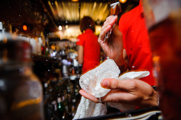 barman chopping ice for cocktails