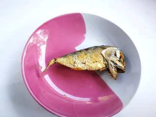 Fried mackerel on the plate. The mackerel fish were cooked by frying. And put them together on a...