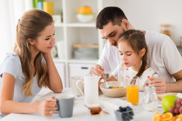 happy family having breakfast at home