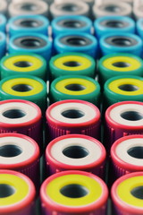 There are many Test Tubes with multicolor lids on the Test Tube rack. Macro photo with Test Tube for blood