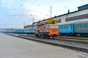 Fototapeta premium Passenger and freight train. Passenger diesel train traveling speed railway wagons journey light