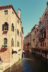 Venice, Italy - August 14, 2017: Venice canal with boats and classic buildings.