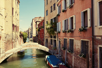 Fototapeta na wymiar Venice, Italy - August 14, 2017: a small bridge across the Venetian canal.