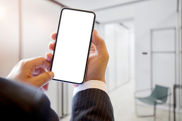 Cropped shot of Unrecognizable businessman using a smartphone in office.
