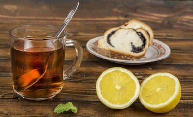 Lemon and cup of tea with mint leaf