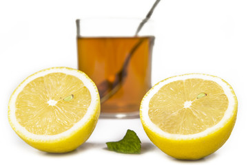 Lemon and cup of tea with mint leaf