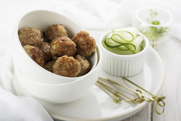 hearty meatballs served in a small bowl.