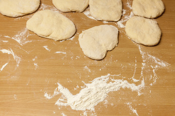 kneading dough on wooden table