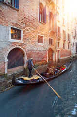 Fototapeta na wymiar Beautiful view of traditional gondola with gondolier on famous Canal Grande