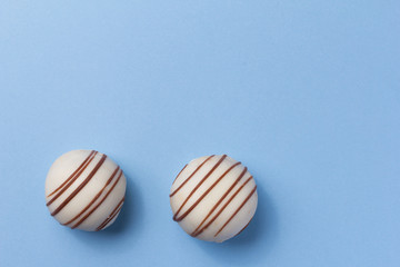 Homemade white chocolate truffle.  Overhead of candy ball on blue table.