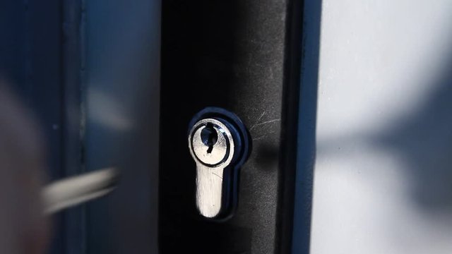 Locking up or unlocking door with key in hand
