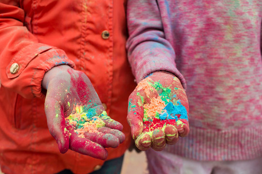 Hands of young people with Indian dyes on Holi color festival