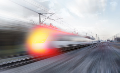Naklejka na ściany i meble High speed train runs on rail tracks . Train in motion.