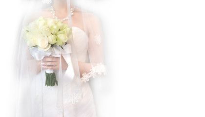 Beautiful wedding bouquet in the hands of the bride in a white dress