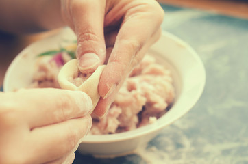The process of making delicious home-made dumplings with meat.