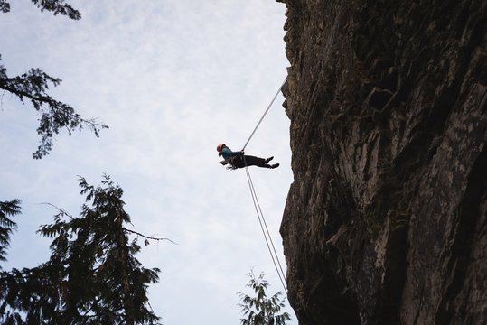 Rock climber climbing the rocky cliff