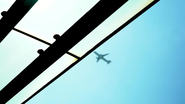 The plane to take off against the background of the blue sky. The airport in Hong Kong. Plane which is flying by along the sky. The plane takes off from the airport. side view