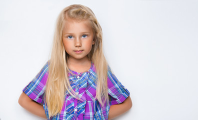 Portrait of a charming blonde little girl, isolated on gray background