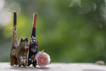 Cat doll made of wood.on the wooden floor.