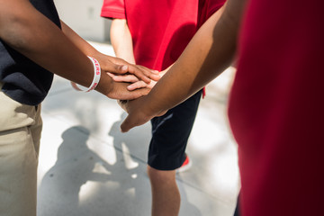 diverse kids team cheering hand pile