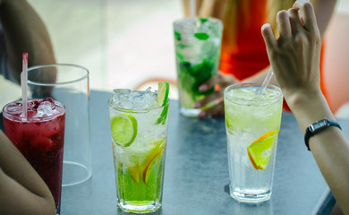 women drink cocktail with ice cube.